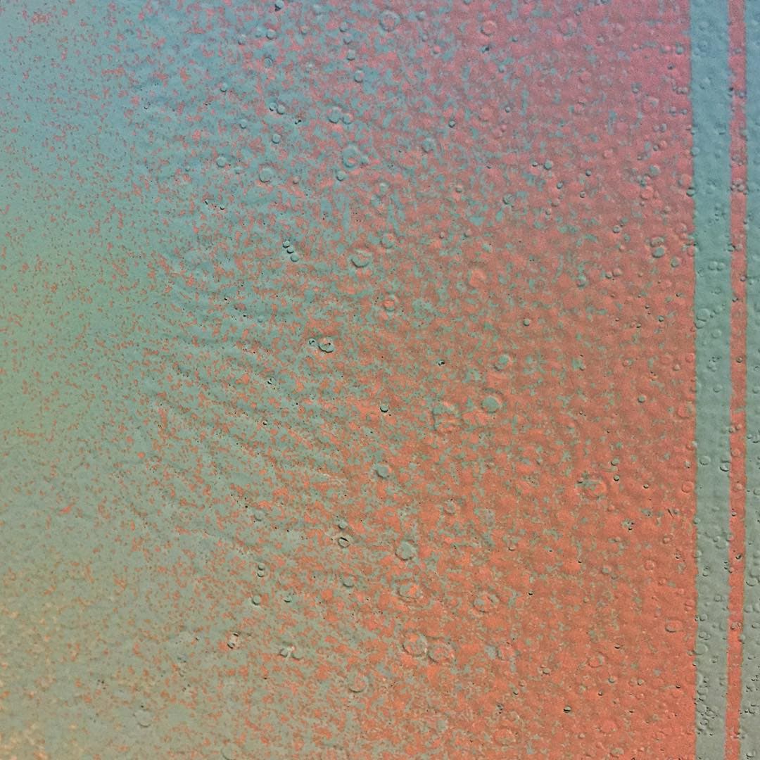 Dry ink on paper closeup creating a moon-like cratered surface.