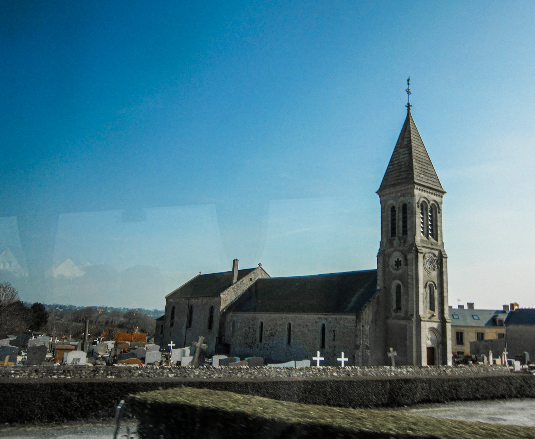 French church with gravestones all around it