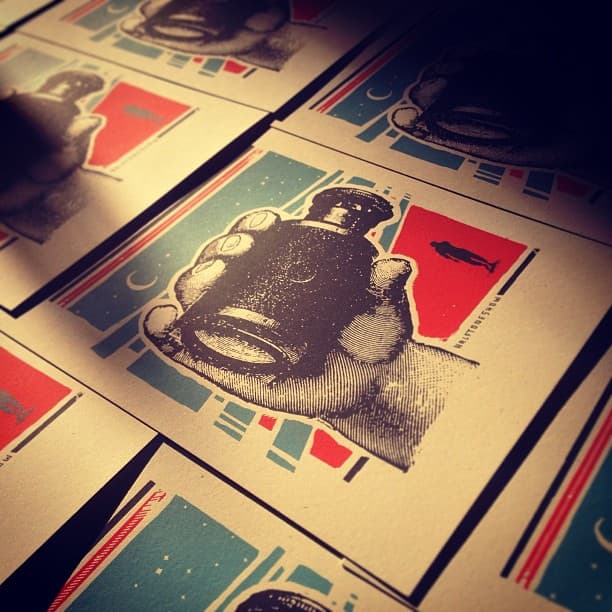 Screen print of a hangd holding a looking glass